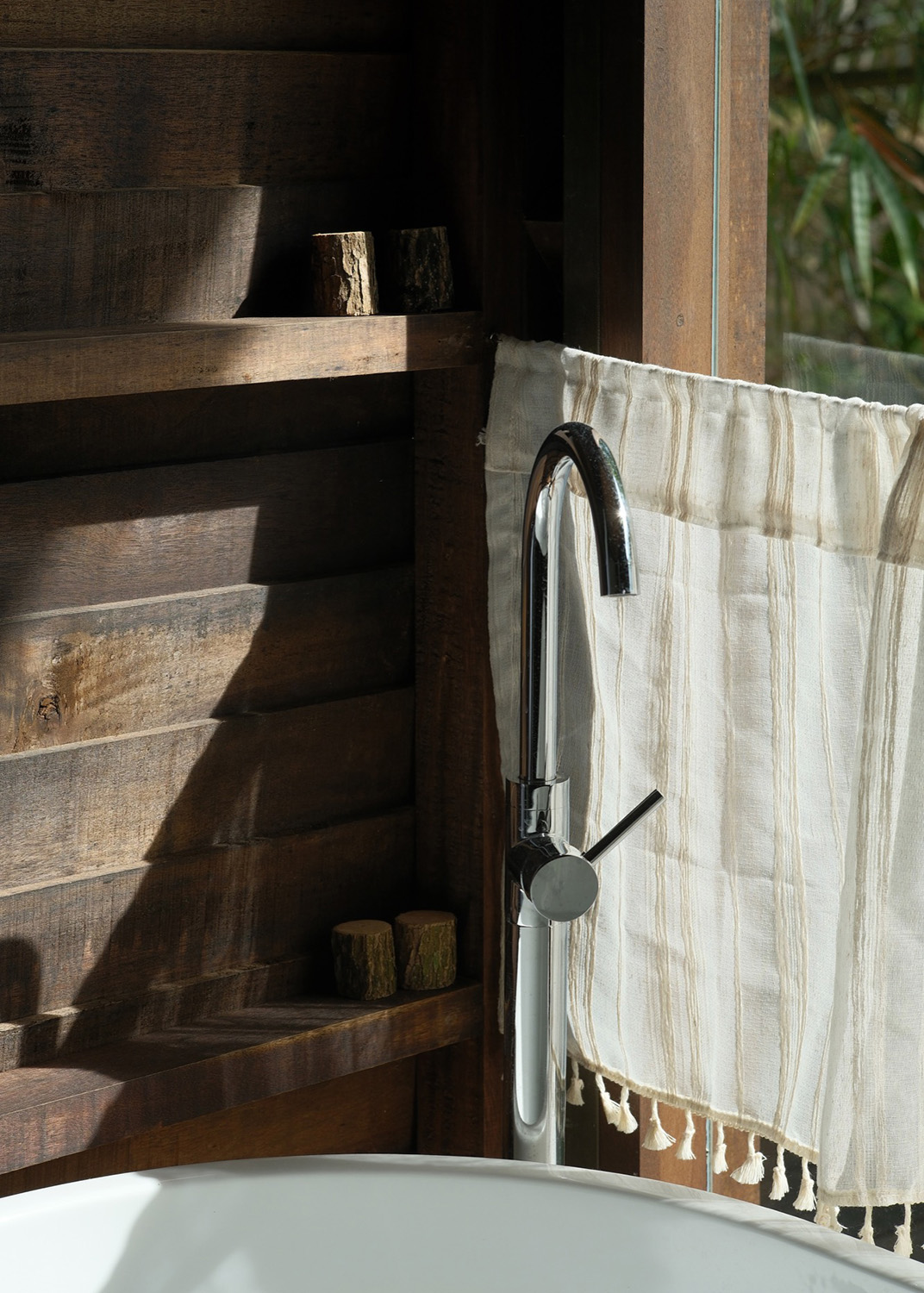 Bathtub detail with wooden shelves